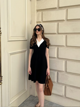 a lady wears a contrast v-neck slim knitted midi dress